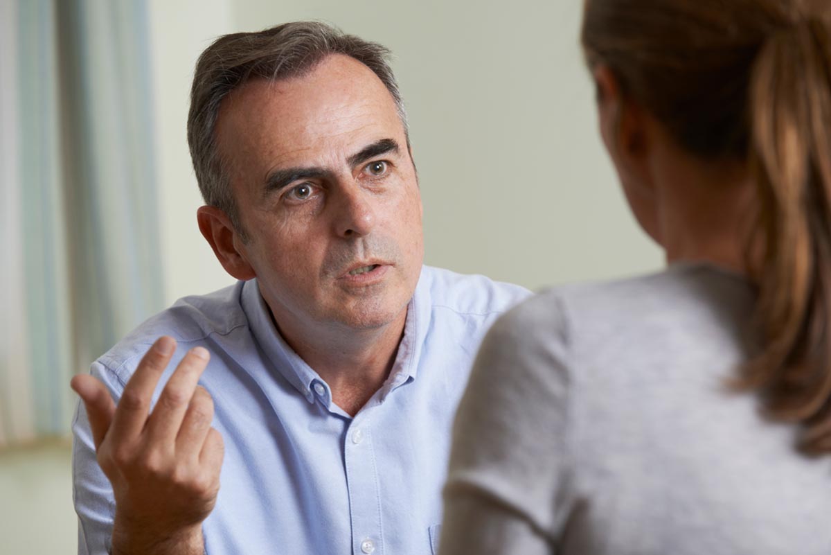 man in blue shirt talks to doctor about buprenorphine use