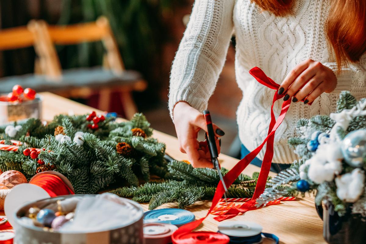 woman prepares holiday decorations