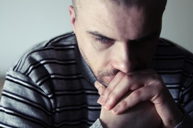 Man with serious facial expression thinking about the effects of the most dangerous drugs