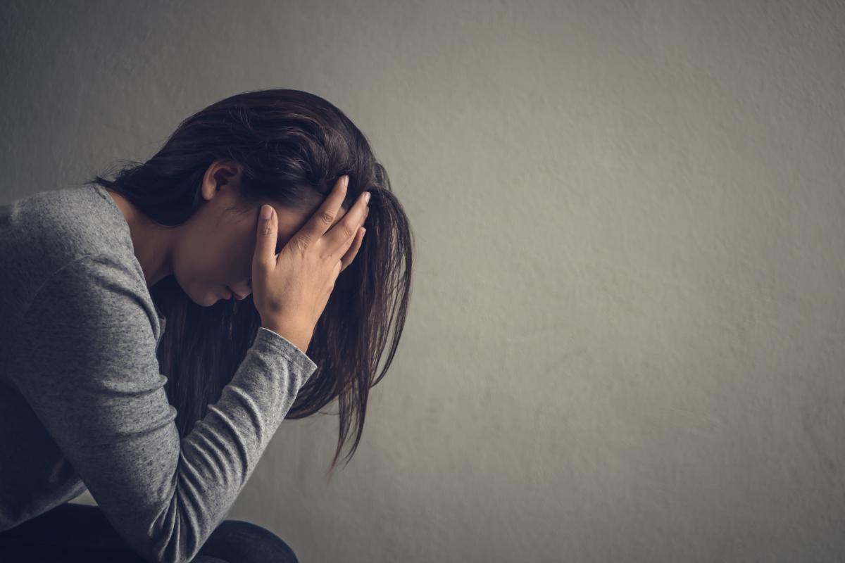 woman with head in hands considering the most addictive drugs in louisville