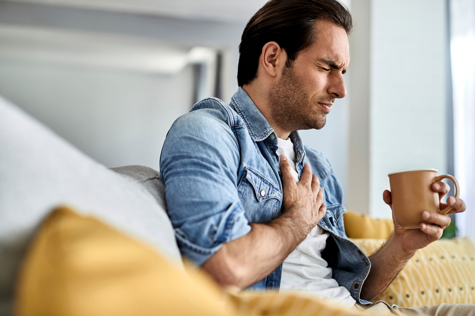 person with hand on chest experiencing the side effects of methadone