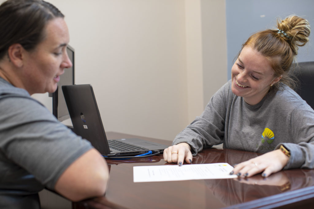 women discussing paperwork in a suboxone clinic in worcester massachusetts