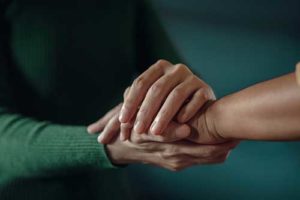 person in green sweater comforting another person in a fentanyl addiction treatment program