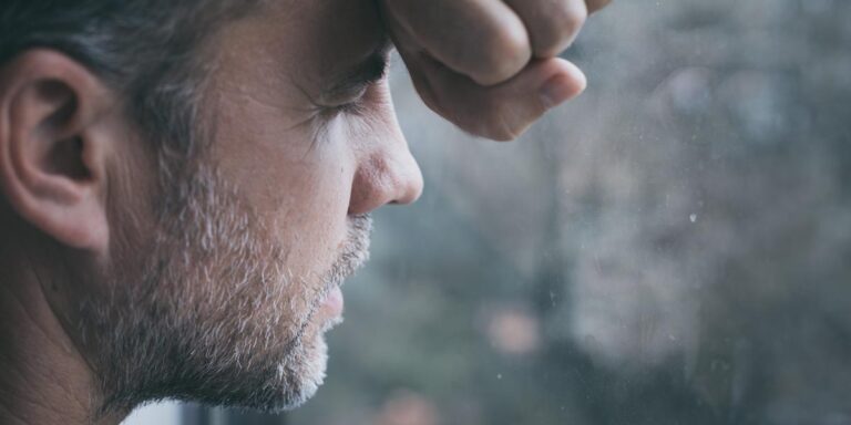 Men facing window with eyes closed contemplating the question how long does it take to become dependent on opioids