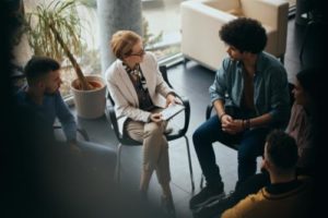 Counselor and group of participants in suboxone treatment programs