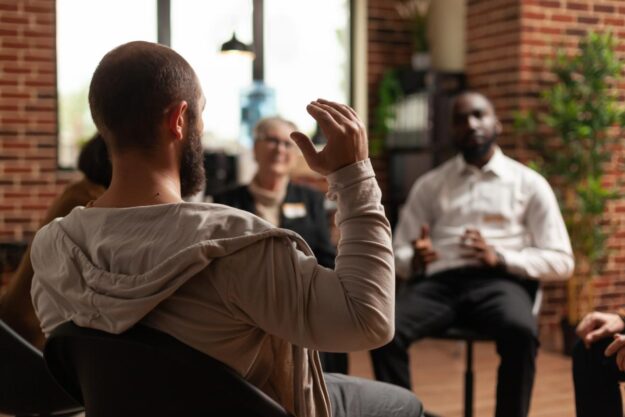 Person participating in group therapy in a drug rehab in Virginia Beach that accepts Medicaid