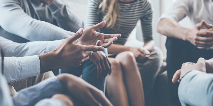 Close-up of circle of people in group therapy at a medicaid drug rehab in madisonville ky