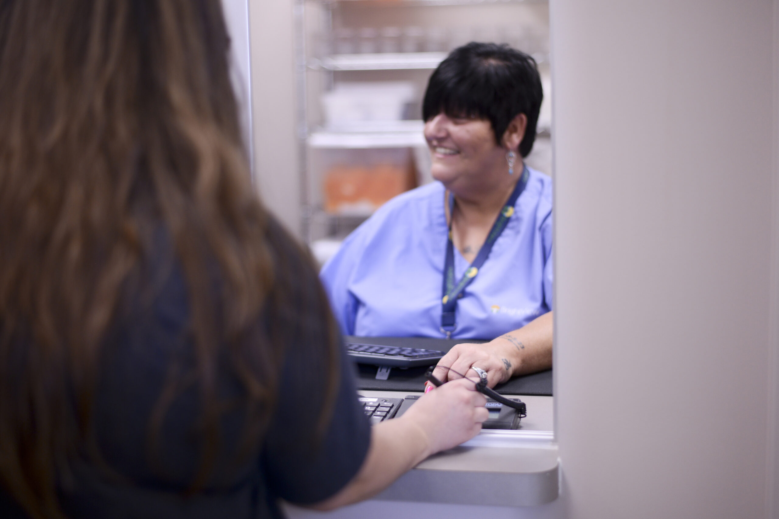 Nurse dispensing medication for medication assisted treatment.