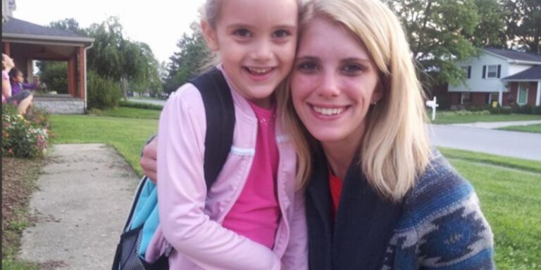 Ariel Smith, Outreach Coordinator for BrightView, poses with her daughter on her first day of school.